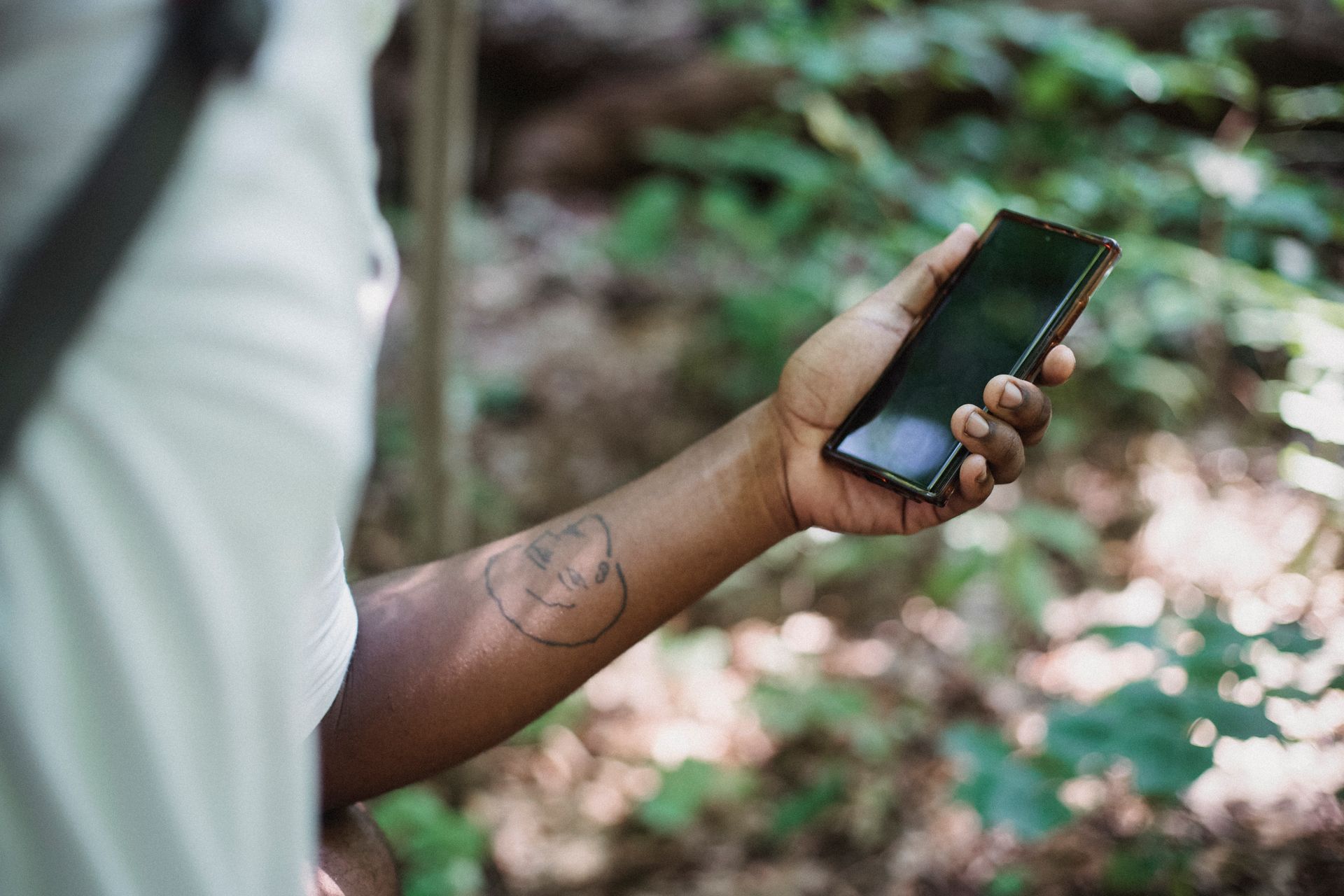 Field logger device held outdoors near water