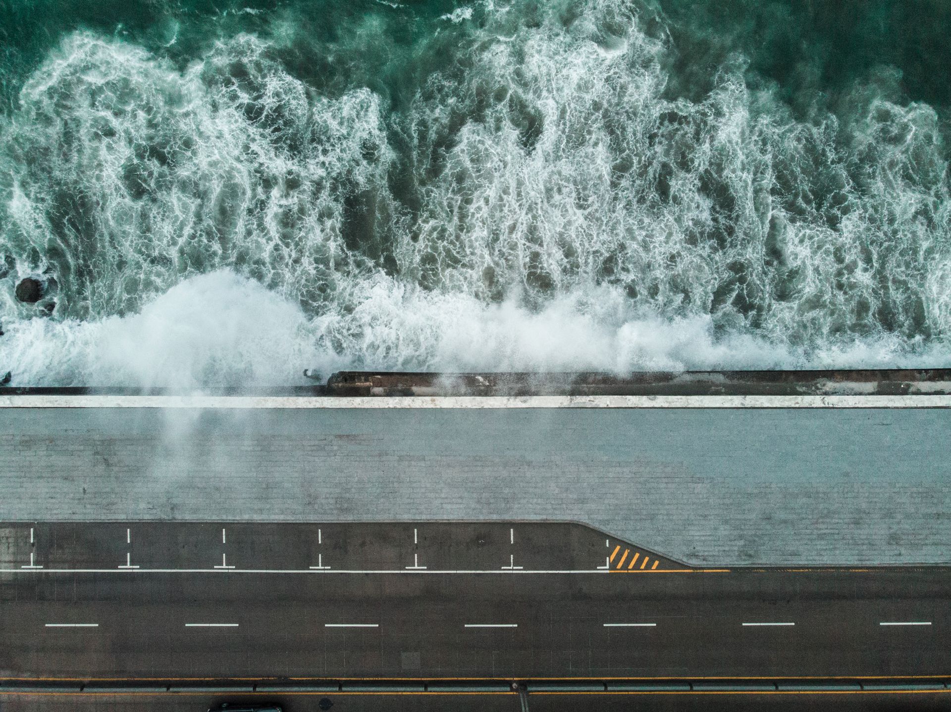 Aerial coastal road hugging the shoreline